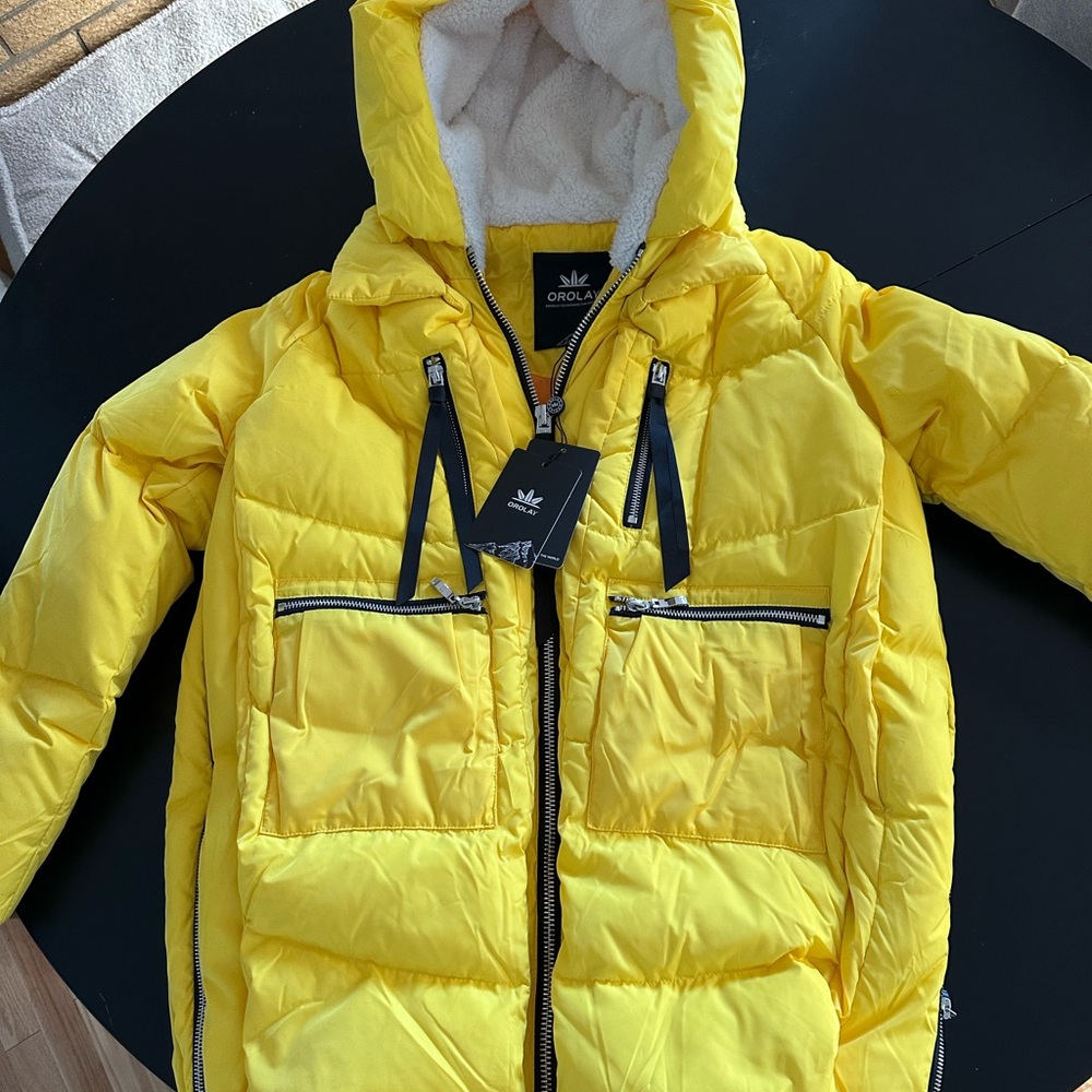 Brand new Orolay jacket in yellow. Size xs.